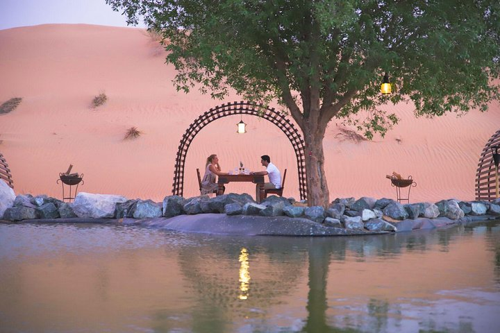 Experience an elegant dinner in a serene desert oasis where fine dining meets breathtaking views creating an unforgettable evening in the heart of Dubai's stunning landscape.